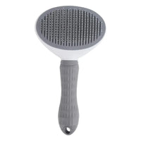 La brosse ovale grise et blanche, à picots fins, vue de face